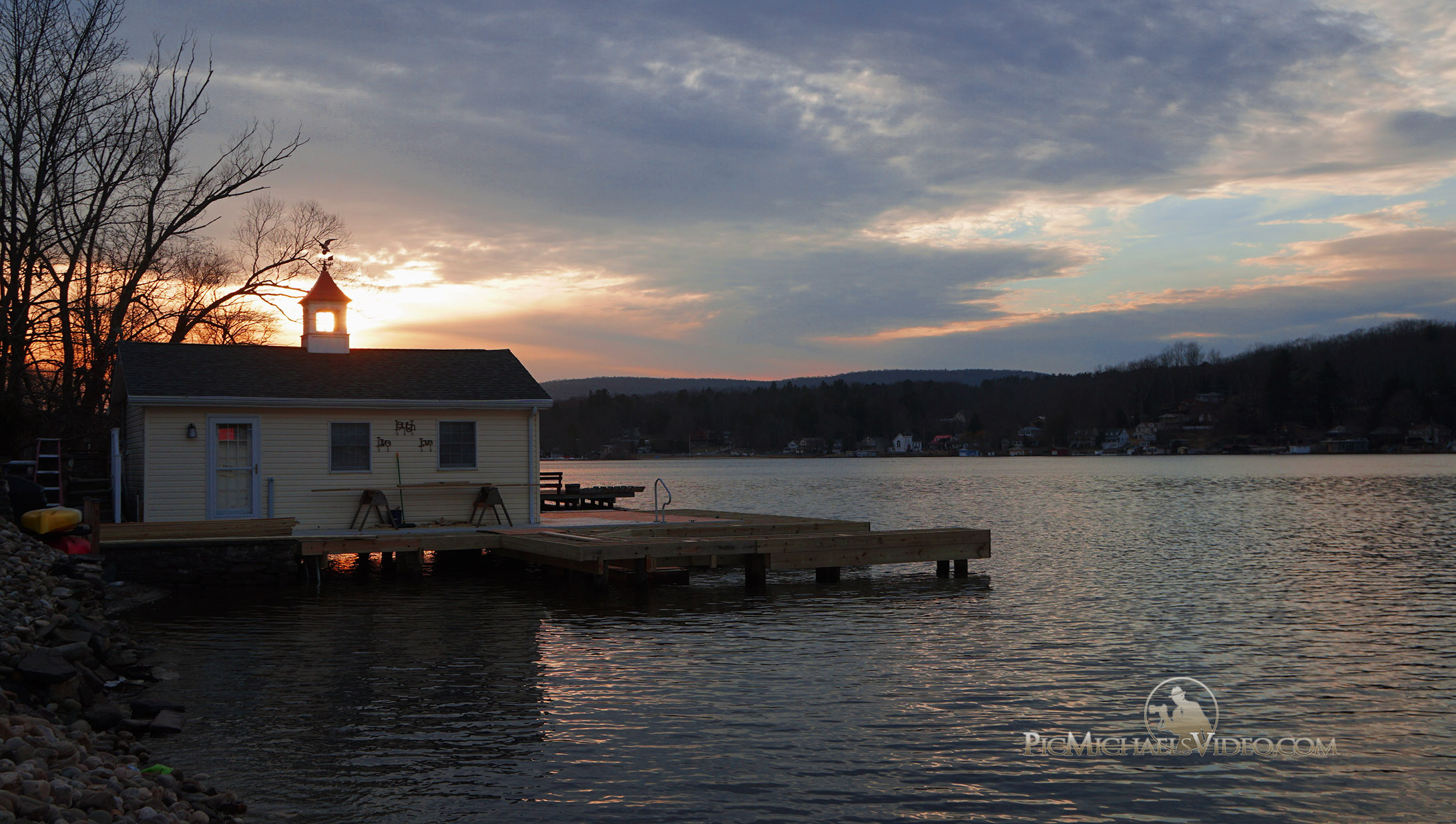 A late winter scene at Harveys Lake in Pennsylvania as the suns sinks slowly behind a boathouse.