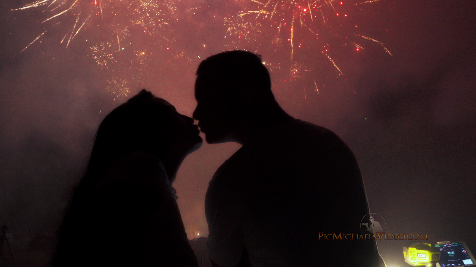Couple Kissing with Fireworks in sky